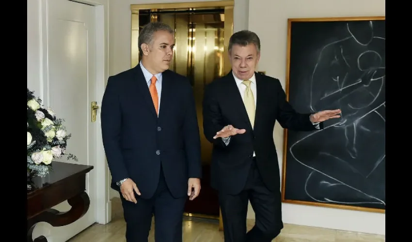 Juan Manuel Santos y  Iván Duque.