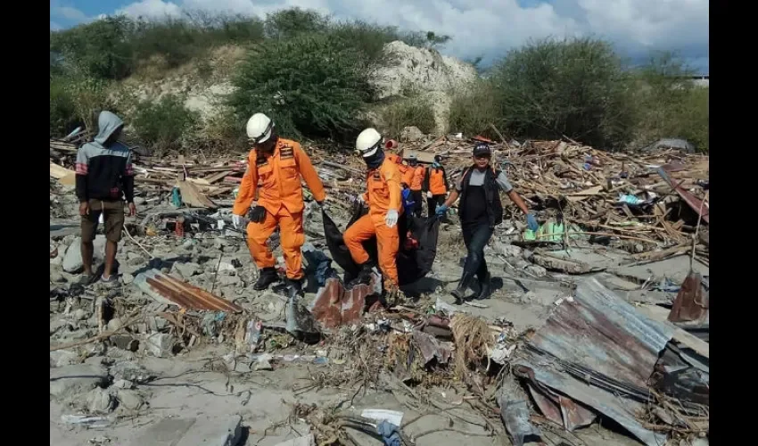 Miembros del personal de rescate mientras cargan con el cuerpo de una víctima mortal en Donggala. Foto cedida a EFE