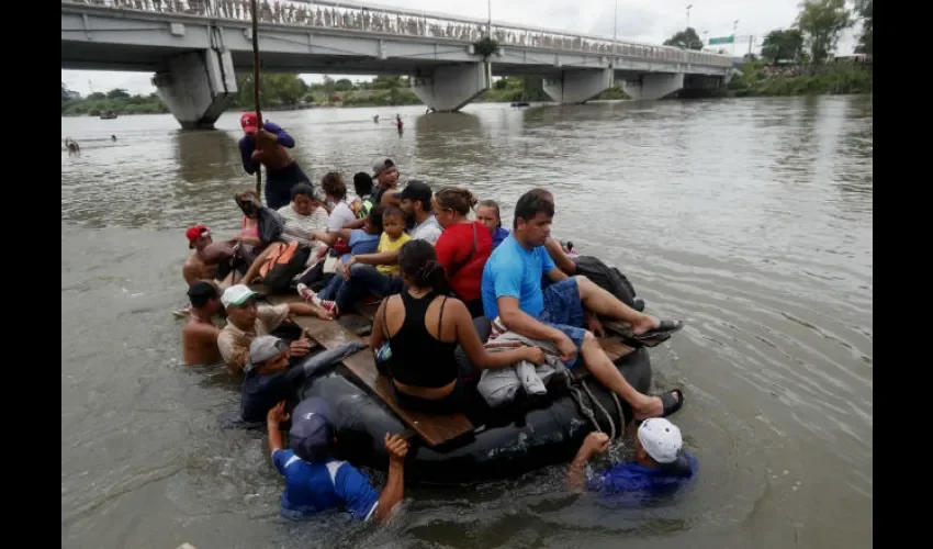 Las personas, agarradas a un lazo, continuaron con la caravana sobre el agua. Foto: EFE