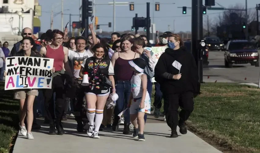 Más de 100 personas, muchas de ellas jóvenes trans, marchan por las inmediaciones del Capitolio de Kansas, en el día anual de la visibilidad trans.
