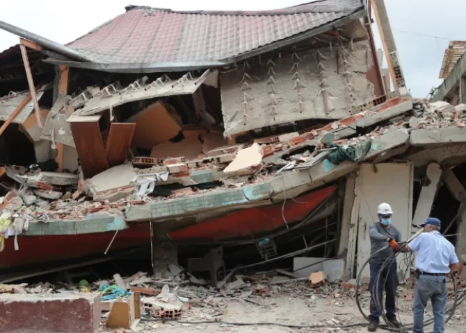   Hombres trabajan este sábado, frente a una casa derrumbada por los terremotos en Venezuela, en El Junquito (Venezuela). EFE/ Ronald Peña R  